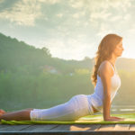 Woman doing yoga on the lake – relaxing in nature