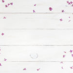 lilac flowers on white wooden background, top view, flat lay